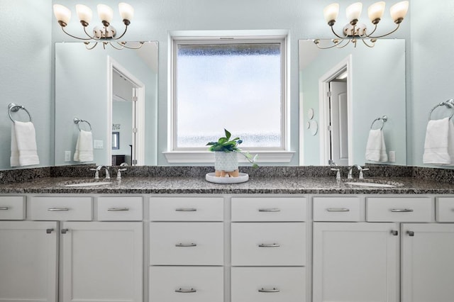full bath featuring a chandelier and double vanity