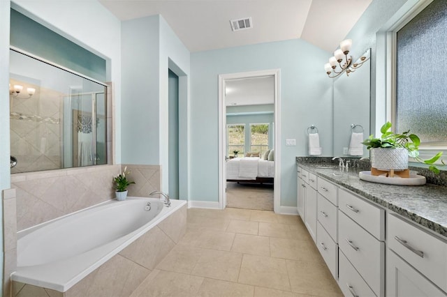 ensuite bathroom with vanity, a stall shower, a bath, tile patterned flooring, and baseboards