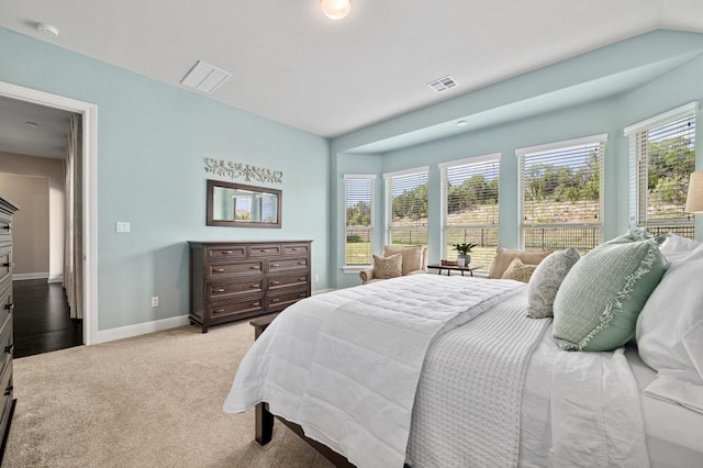 bedroom featuring light carpet and baseboards