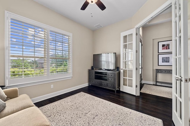 living area with french doors, dark wood-style flooring, baseboards, and a ceiling fan