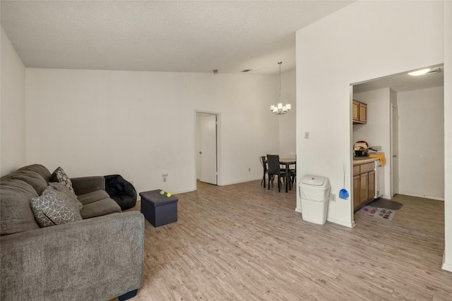 515 Sierra Cv, Round Rock, TX 78664 - living room with a chandelier, vaulted ceiling, and light wood-style floors