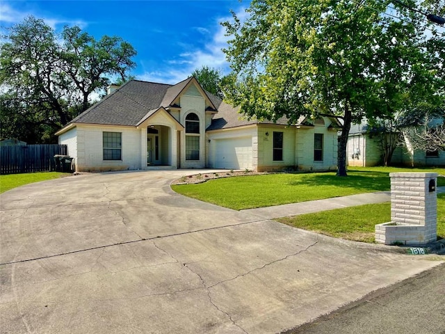 view of front of property featuring driveway, an attached garage, and roof with shingles