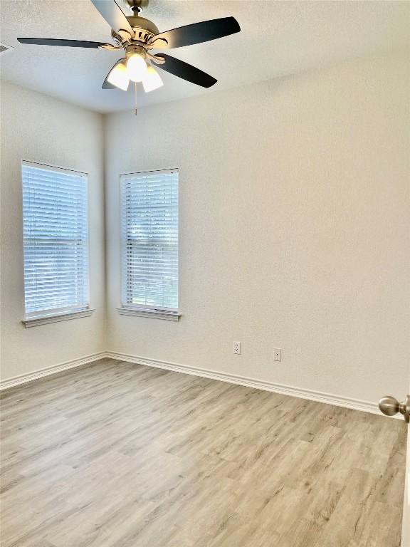 1816 Lancaster St, San Marcos, TX 78666 - unfurnished room featuring wood finished floors, baseboards, and a ceiling fan