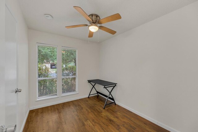 9811 Hansford Dr, Austin, TX 78753 - spare room with baseboards, wood finished floors, and ceiling fan