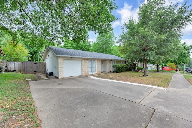 9811 Hansford Dr, Austin, TX 78753 - single story home featuring a garage, concrete driveway, brick siding, roof with shingles, and a gate