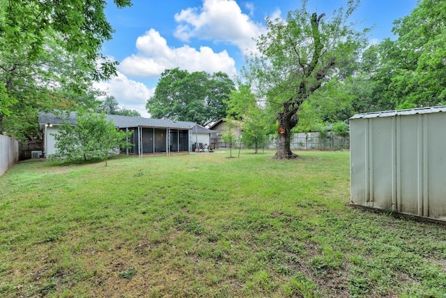 9811 Hansford Dr, Austin, TX 78753 - view of yard featuring a sunroom, an outbuilding, and a shed