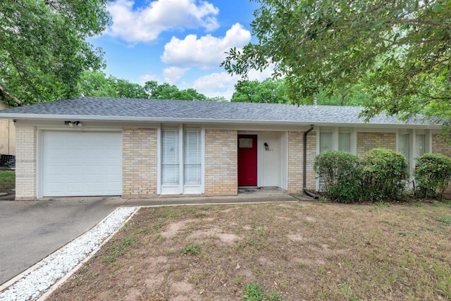 9811 Hansford Dr, Austin, TX 78753 - single story home featuring an attached garage, brick siding, driveway, and a shingled roof