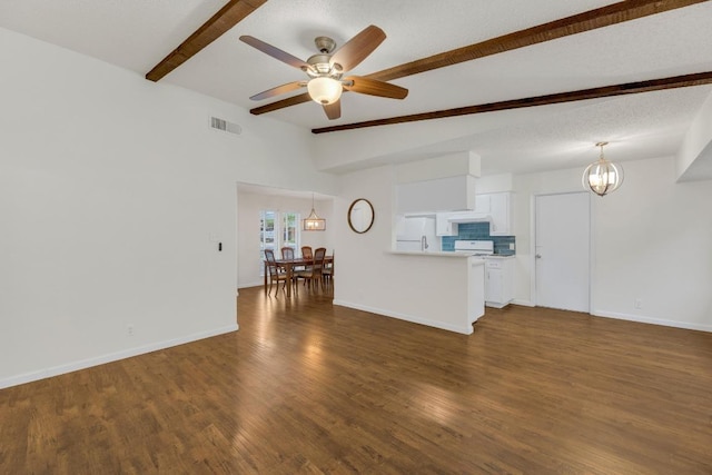 9811 Hansford Dr, Austin, TX 78753 - living area with beam ceiling, ceiling fan, dark wood-style floors, and a chandelier