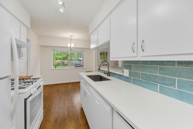9811 Hansford Dr, Austin, TX 78753 - kitchen with a sink, white appliances, dark wood finished floors, and decorative backsplash