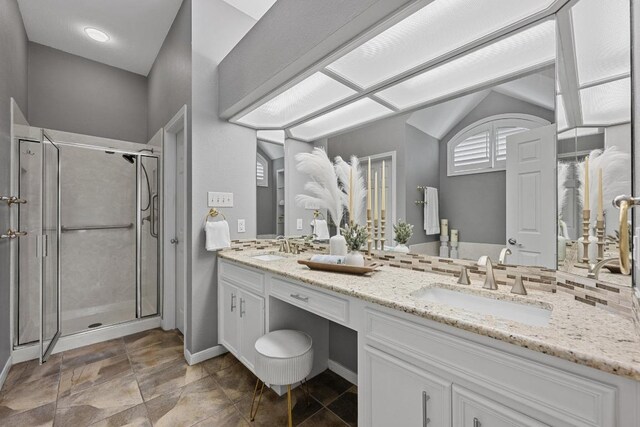 1013 Pecan Creek Dr, Pflugerville, TX 78660 - full bath featuring double vanity, a stall shower, baseboards, and stone finish flooring