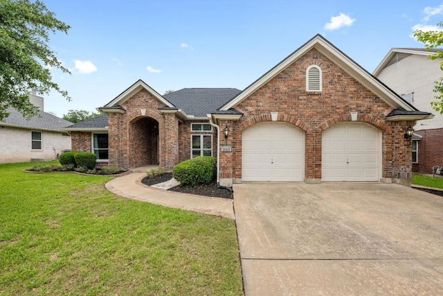 1013 Pecan Creek Dr, Pflugerville, TX 78660 - view of front facade featuring concrete driveway, a garage, brick siding, a front yard, and a shingled roof