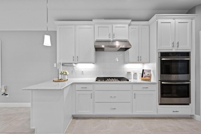 1013 Pecan Creek Dr, Pflugerville, TX 78660 - kitchen with under cabinet range hood, stainless steel appliances, white cabinets, and tasteful backsplash