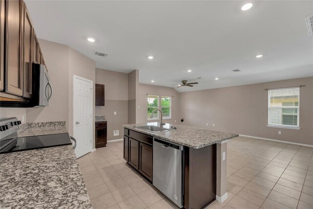 625 Taggart Trl, Jarrell, TX 76537 - kitchen with stainless steel appliances, a sink, light tile patterned floors, open floor plan, and recessed lighting