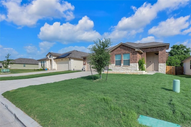 625 Taggart Trl, Jarrell, TX 76537 - ranch-style house with concrete driveway, stone siding, an attached garage, brick siding, and a shingled roof