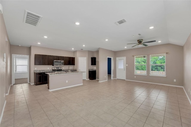 625 Taggart Trl, Jarrell, TX 76537 - kitchen with appliances with stainless steel finishes, open floor plan, a sink, baseboards, and recessed lighting