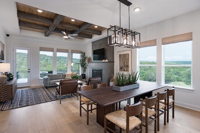 305 Golden Sage Ave, Georgetown, TX 78633 - dining space featuring recessed lighting, light wood finished floors, coffered ceiling, a fireplace, and ceiling fan