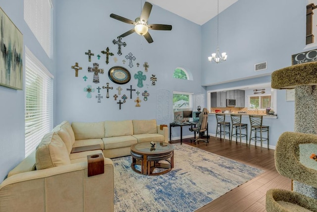 3400 Settlement Dr, Round Rock, TX 78665 - living area with high vaulted ceiling, wood finished floors, a chandelier, and a ceiling fan
