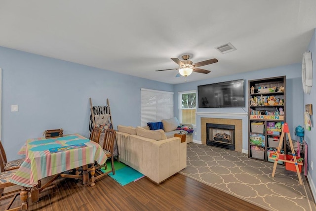 3400 Settlement Dr, Round Rock, TX 78665 - living room with wood finished floors, a ceiling fan, a fireplace, and baseboards