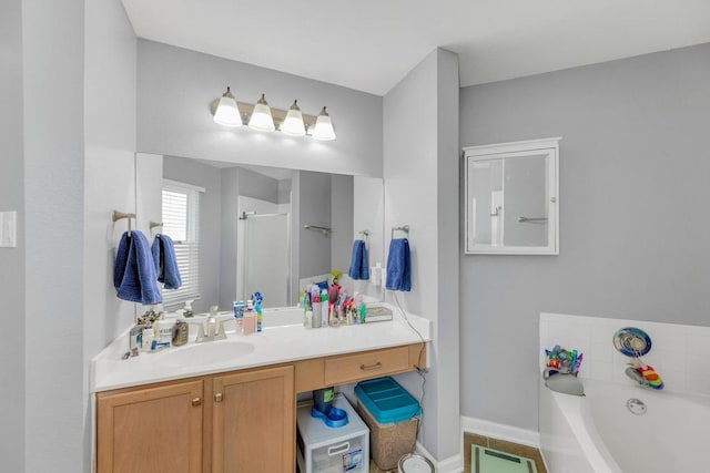 3400 Settlement Dr, Round Rock, TX 78665 - bathroom featuring a bath, vanity, baseboards, and a shower stall