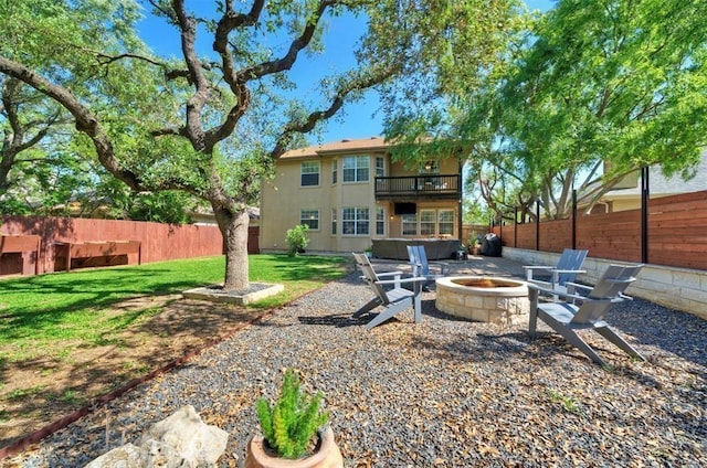 11805 Lake Stone Dr, Austin, TX 78738 - rear view of house featuring a balcony, an outdoor fire pit, stucco siding, and a patio area