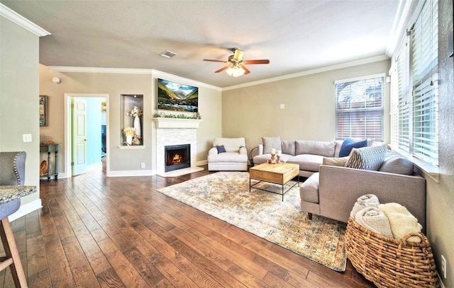 11805 Lake Stone Dr, Austin, TX 78738 - living area featuring dark wood-style floors, a fireplace with flush hearth, ceiling fan, crown molding, and baseboards