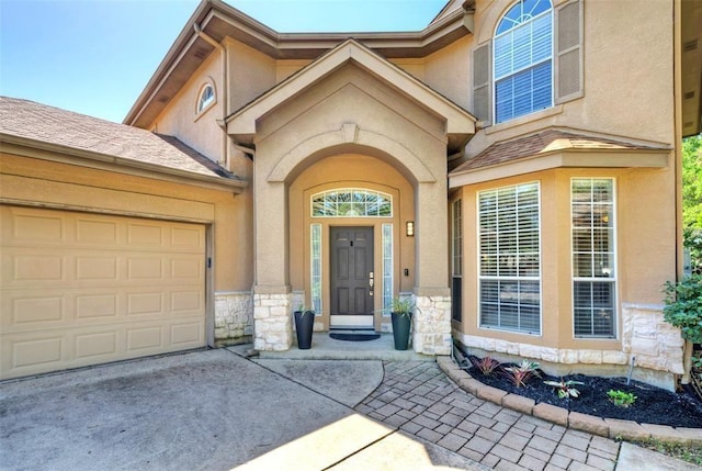 11805 Lake Stone Dr, Austin, TX 78738 - entrance to property featuring stone siding, concrete driveway, stucco siding, and a garage