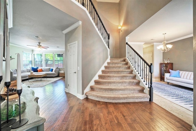 11805 Lake Stone Dr, Austin, TX 78738 - stairs with ornamental molding, hardwood / wood-style floors, a ceiling fan, and baseboards