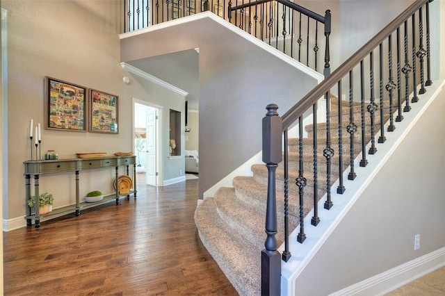 11805 Lake Stone Dr, Austin, TX 78738 - stairway featuring a towering ceiling, baseboards, wood finished floors, and crown molding