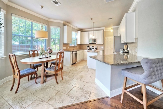 11805 Lake Stone Dr, Austin, TX 78738 - kitchen with appliances with stainless steel finishes, ornamental molding, a sink, tasteful backsplash, and stone counters