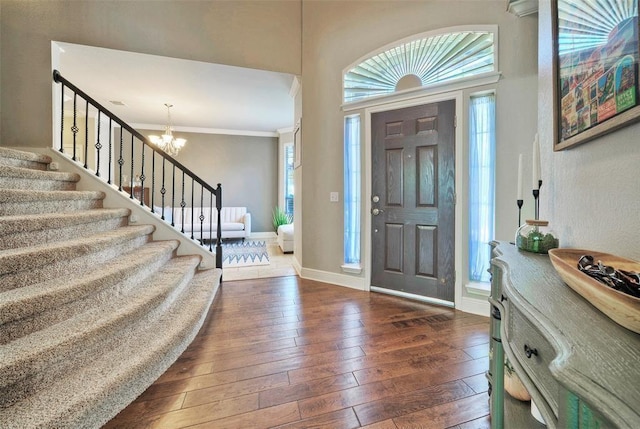 11805 Lake Stone Dr, Austin, TX 78738 - foyer featuring stairway, a chandelier, dark wood-style flooring, ornamental molding, and baseboards