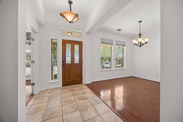 141 Stratton Ct, Austin, TX 78737 - foyer entrance featuring a chandelier and light wood finished floors