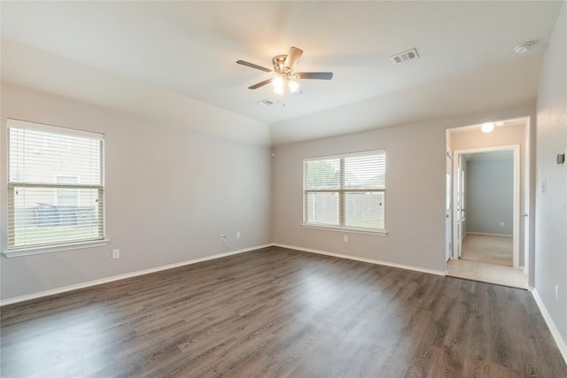 unfurnished room with dark wood-style flooring, ceiling fan, baseboards, vaulted ceiling, and a smoke detector