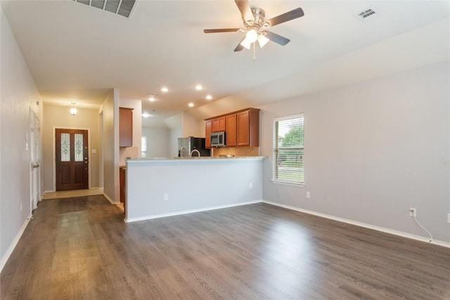 unfurnished living room featuring dark wood-type flooring, baseboards, ceiling fan, and recessed lighting