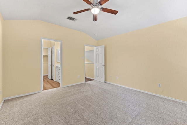 9216 Vigen Cir, Austin, TX 78748 - unfurnished bedroom featuring light colored carpet, vaulted ceiling, baseboards, ensuite bathroom, and ceiling fan