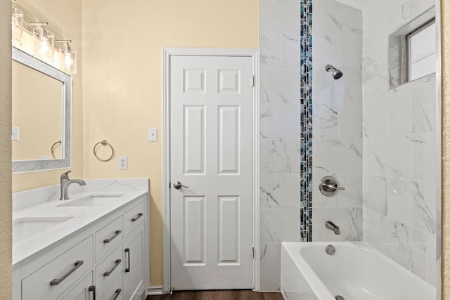 9216 Vigen Cir, Austin, TX 78748 - full bath featuring double vanity, shower / bathtub combination, and wood finished floors