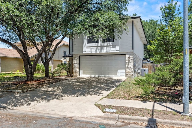 9216 Vigen Cir, Austin, TX 78748 - view of front of home with an attached garage, driveway, and stone siding