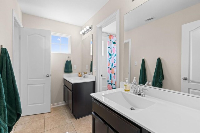 8058 Arezzo Dr, Round Rock, TX 78665 - full bathroom featuring two vanities, tile patterned flooring, and a shower with shower curtain