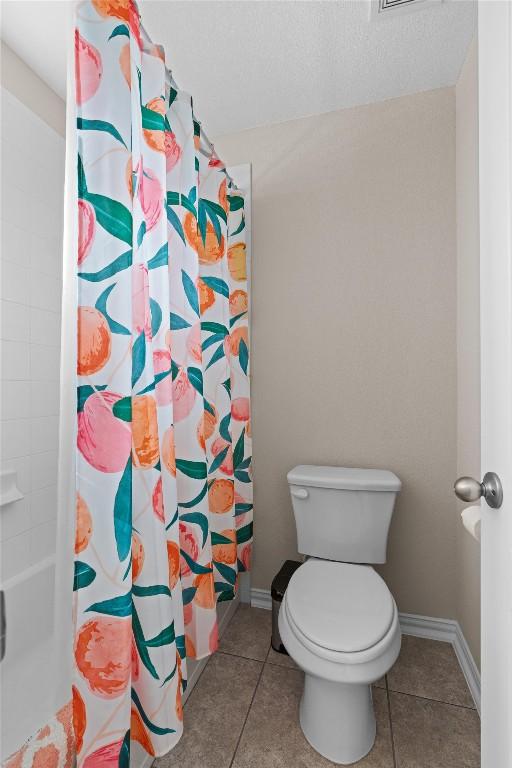 8058 Arezzo Dr, Round Rock, TX 78665 - bathroom with a shower with curtain and tile patterned flooring