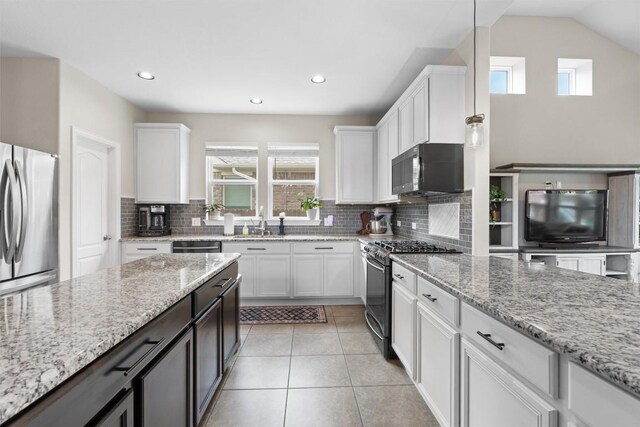 8058 Arezzo Dr, Round Rock, TX 78665 - kitchen featuring stainless steel appliances, white cabinetry, backsplash, light stone counters, and recessed lighting