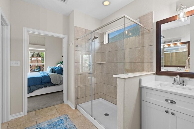 8058 Arezzo Dr, Round Rock, TX 78665 - bathroom with ensuite bathroom, a stall shower, tile patterned flooring, and vanity