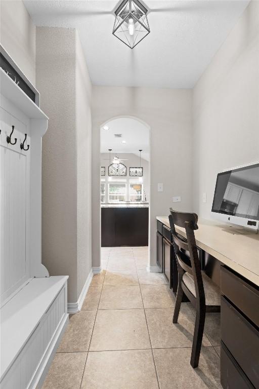 8058 Arezzo Dr, Round Rock, TX 78665 - office area with light tile patterned floors, arched walkways, and built in study area