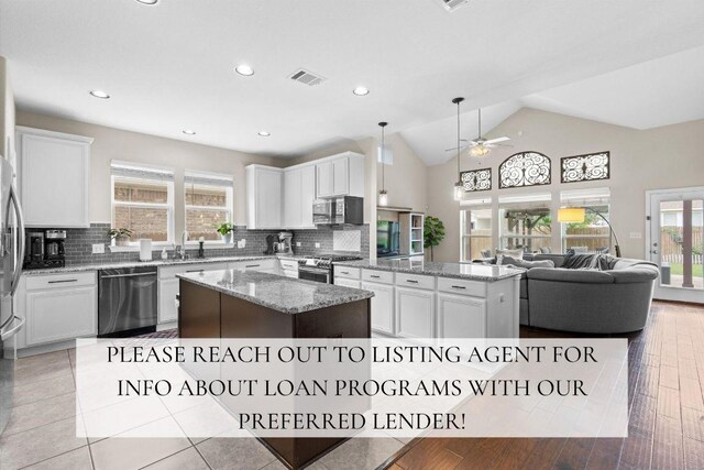 8058 Arezzo Dr, Round Rock, TX 78665 - kitchen featuring stainless steel appliances, a kitchen island, open floor plan, ceiling fan, and backsplash