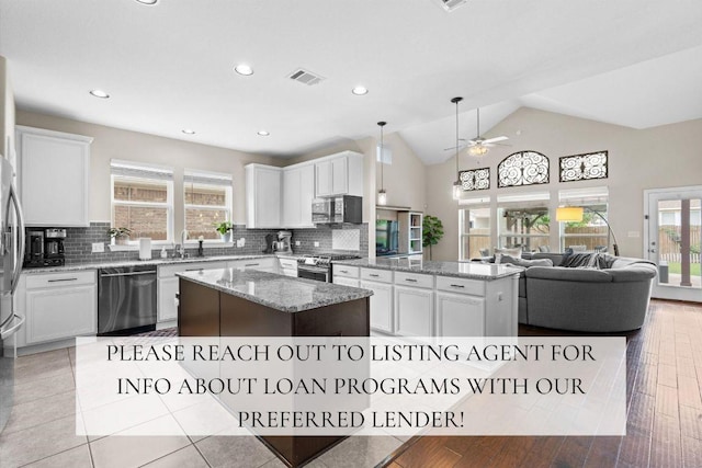 8058 Arezzo Dr, Round Rock, TX 78665 - kitchen with stainless steel appliances, a center island, open floor plan, ceiling fan, and backsplash