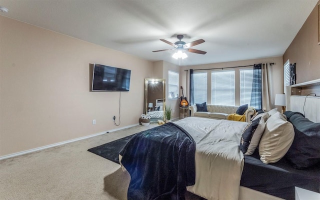 carpeted bedroom featuring baseboards and ceiling fan
