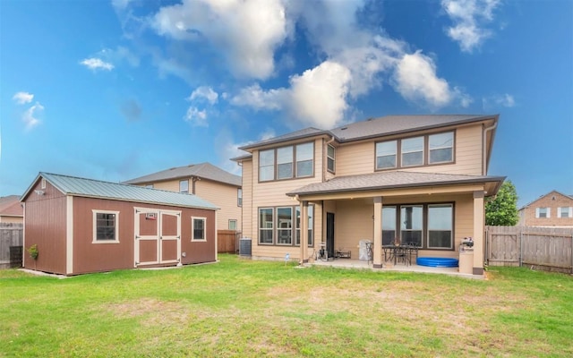 316 Carrington St, Hutto, TX 78634 - back of house featuring a storage unit, a fenced backyard, and a patio