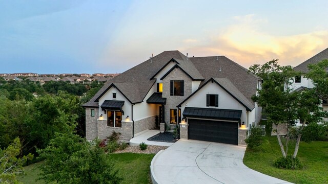 321 Cumberland Cv, Georgetown, TX 78628 - view of front of house featuring a shingled roof, a front yard, driveway, and stone siding