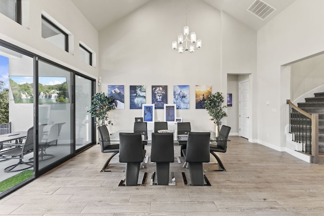 321 Cumberland Cv, Georgetown, TX 78628 - dining space with high vaulted ceiling, a chandelier, light wood-type flooring, stairway, and plenty of natural light