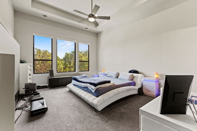 321 Cumberland Cv, Georgetown, TX 78628 - carpeted bedroom with a tray ceiling, ceiling fan, and baseboards