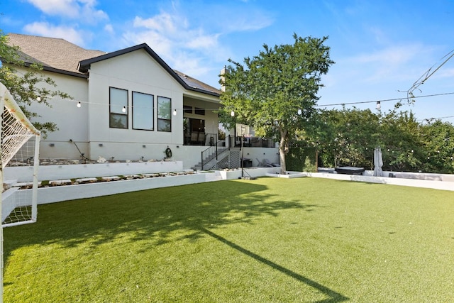 321 Cumberland Cv, Georgetown, TX 78628 - view of front of property featuring a front lawn, stucco siding, stairs, and roof with shingles