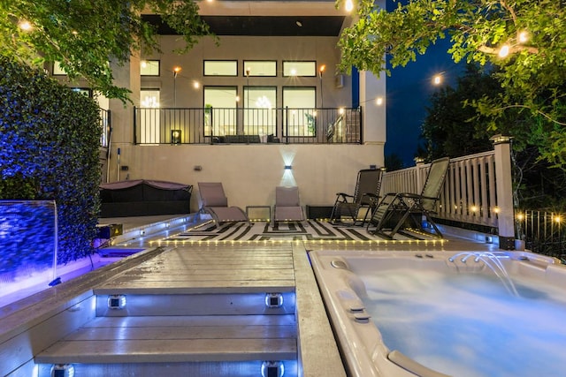321 Cumberland Cv, Georgetown, TX 78628 - pool at night featuring an outdoor hot tub and a wooden deck